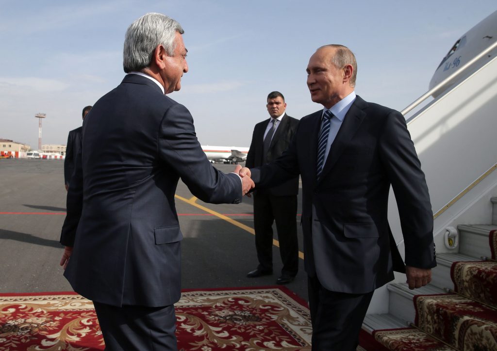 Russian President Vladimir Putin (R) shakes hands with Armenian President Serzh Sargsyan as he arrives at the Yerevan airport on Oct. 14, 2016. MIHAIL METZEL/AFP/Getty Images